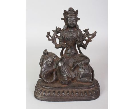 A GOOD CHINESE MING DYNASTY IRON MODEL OF THE BODHISATTVA SAMANTABHADRA SEATED IN LALITASANA ON HIS ELEPHANT, and supported o
