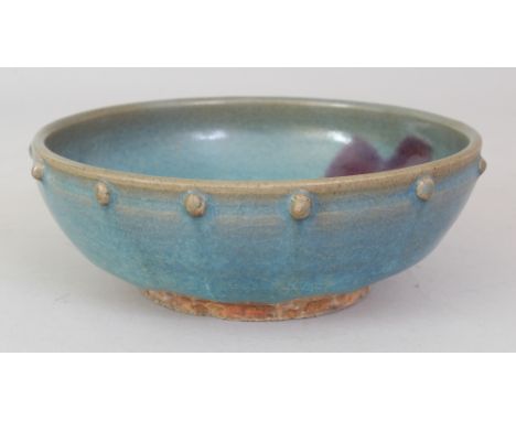 A CHINESE JUN WARE PURPLE SPLASH CERAMIC BOWL, the rim with a moulded stud border, the base unglazed, 6.5in diameter at rim &