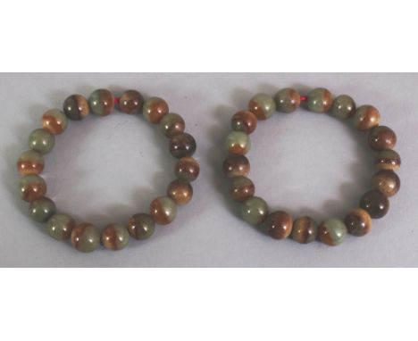 A PAIR OF CHINESE JADE-LIKE HARDSTONE BRACELETS, composed of spherical beads.