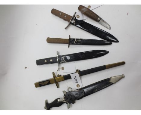 A Group Of WWII Period Daggers Comprising a Third Reich 1933 Pattern SS man's dagger of characteristic form, no. 8301, the bl