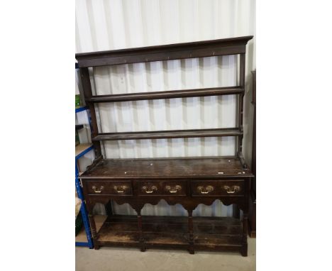 19th century Oak Dresser with open rack above a base with three drawers, shaped apron, turned and block supports and pot shel