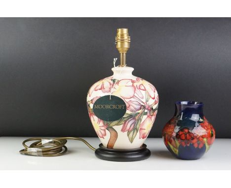 Moorcroft Table Lamp in the Frangipani pattern, 29cms high together with a Moorcroft Vase decorated in the Iris Pattern, 13cm