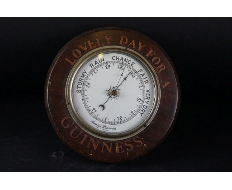 Guinness Advertising - Wooden Cased Circular Aneroid Barometer, inscribed ’ Lovely Day for a Guinness ’, 21.5cms diameter