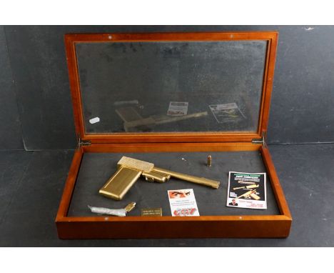 Replica  Reproduction scratch built model of the James Bond golden gun contained within display case. 