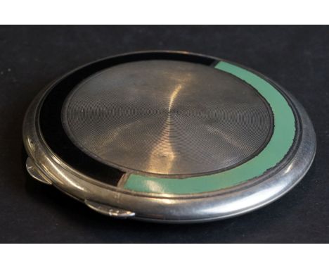 An Art Deco hallmarked silver compact with enamel and engine turned decoration. 