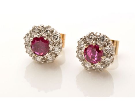 A pair of diamond and ruby cluster stud earrings, the central circular facet cut rubies claw set surrounded by eight diamonds