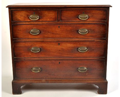 A Georgian mahogany chest of two short and three long graduated drawers fitted embossed brass handles, raised on bracket feet