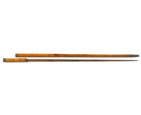 A Victorian malacca sword stick, the tapering cane with gilt metal mounts and patinated metal tip, the double-edged tapering 