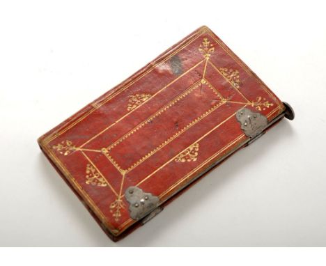 An early 19th Century tooled leather and white metal mounted notebook with pin, engraved with the Sikes crest, 5 1/4in. (13.5