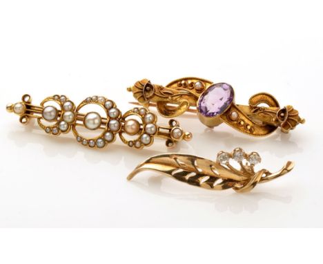 A Victorian amethyst and seed pearl Etruscan style bar brooch, the oval facet cut amethyst flanked by seed pearls amongst bea