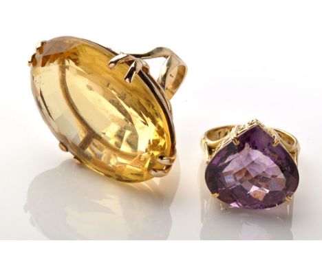 Two gemstone dress rings, to include: an oval facet cut citrine, 3.8 x 24 x 13.5mm, set in four double claws on openwork moun