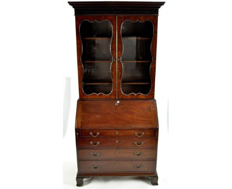 A George III mahogany bureau bookcase, with a flared cornice above a dentil and blind fret carved frieze, a pair of glazed pa