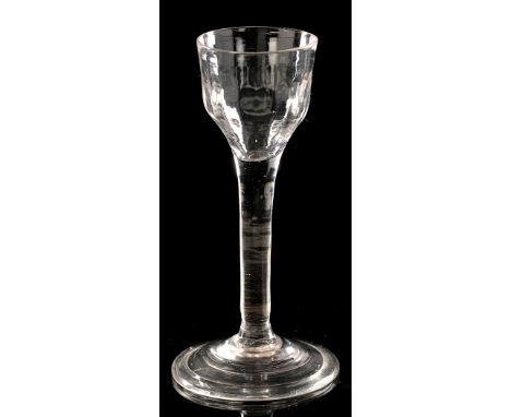 Plain stem wine glass, the ogee bowl with faint fluting, on folded conical foot, mid 18th Century, height 14.8cms.

PROVENANC