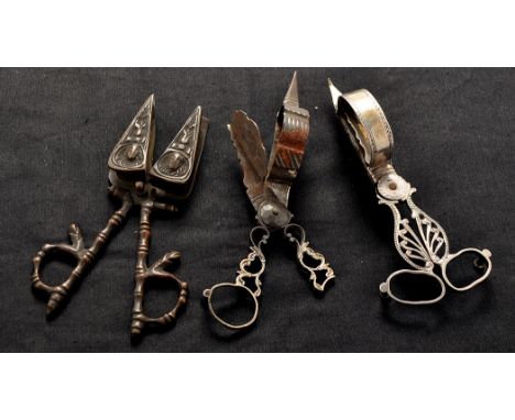 A pair of Georgian plated candle snuffers, with pierced anthemion design and loop handle, engraved Sikes crest; an unusual pa