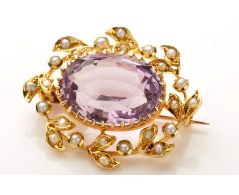 An amethyst, seed pearl and yellow metal brooch, the oval facet cut amethyst claw set, surrounded by seed pearls in a wreath 