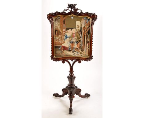 A large Victorian rosewood screen with tapestry panel depicting an elderly couple sitting on a parlour bench (Darby and Joan)
