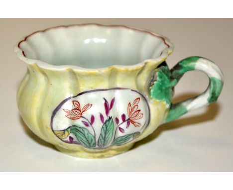 Derby salt bowl, of reeded bulbous form with everted rim having yellow-green enamel ground with floral reserve panels, loop h