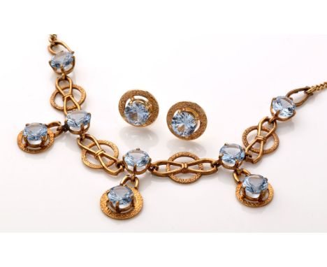 A spinel and yellow metal necklace, the main necklace set with five circular facet cut light blue spinels, separated by circl