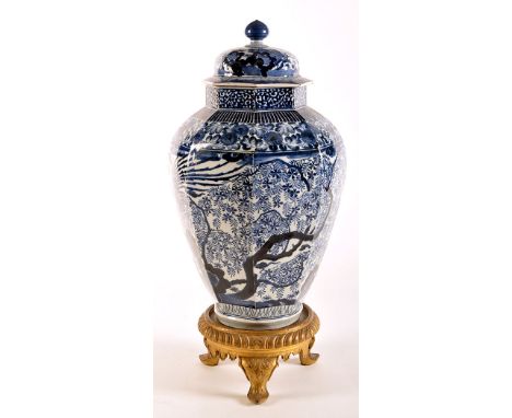 Large Japanese blue and white Arita octagonal vase and cover, painted with exotic birds amongst flowers and foliage, surmount