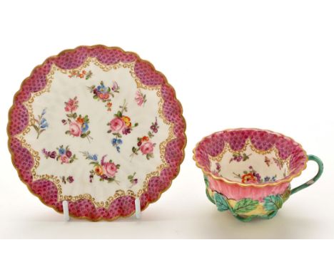 Chinese Famille Rose tea bowl and saucer, the exteriors with applied foliate sinews forming the handle and circular foot, pai