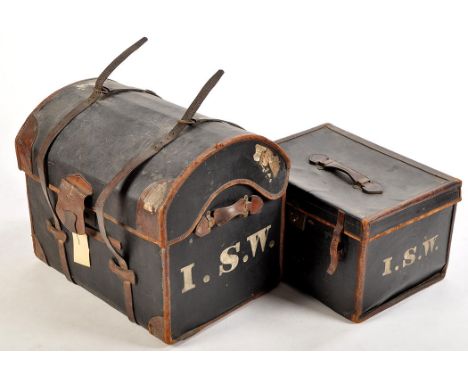 A black cloth and leather mounted dome topped trunk, 27in. (69cms) wide; together with a smaller matching travelling case, by