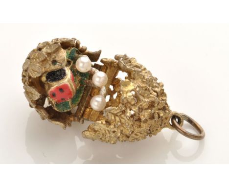 Stuart Devlin: a silver gilt surprise egg pattern pendant of floral and leaf pattern design, opening to reveal enamelled lady