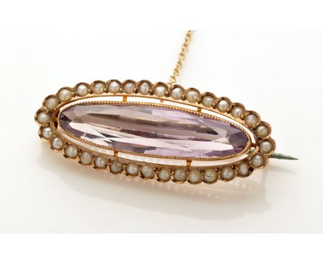 An amethyst and seed pearl brooch, the oval facet cut amethyst millegrain set within a shaped bezel of seed pearls, 3.5cms wi