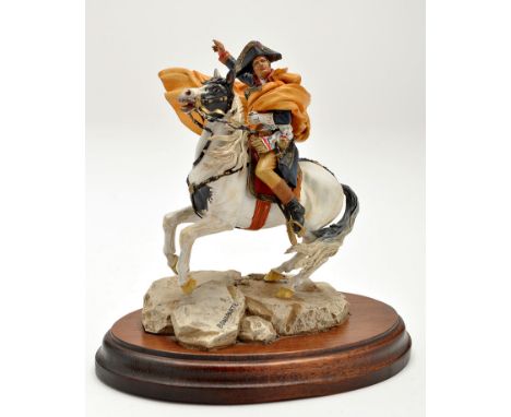 A cast metal figure Napoleon, after equestrian portrait by Jacques Louis David, on hardwood stand, height 16.5cms.