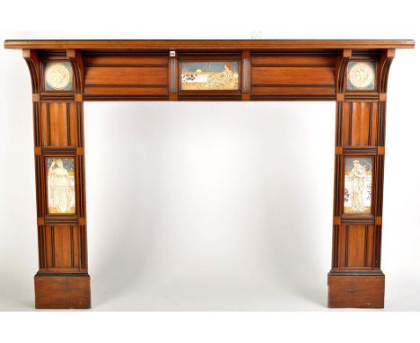 An Edwardian walnut Arts & Crafts design fire surround, with broad shelf above reeded and moulded panels interspersed with de