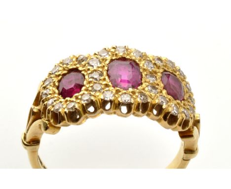 A ruby and diamond triple cluster ring, set with three graduated oval facet cut rubies surrounded by many eight-cut diamonds,