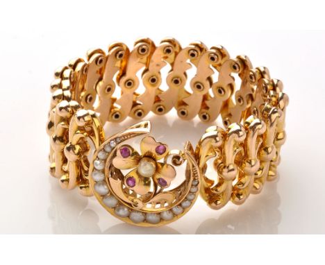 A Victorian yellow metal, seed pearl and ruby bracelet, the main plaque of crescent moon set with graduated seed pearls, cent