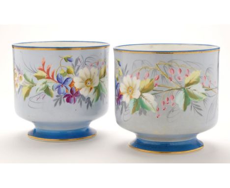 Pair of bone china cache pots, grey blue ground painted with floral sprays, light blue rims and feet, height 18.5cms. (2)