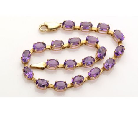An amethyst set 9ct. gold bracelet, the twenty oval facet cut amethysts claw set, 18cms long.