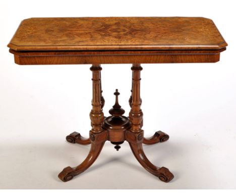 A Victorian burr walnut rectangular shaped swivel top card table, decorated with inlaid stringing and scrolls, opening to rev