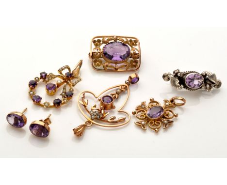 A quantity of amethyst set jewellery, to include: a brooch with central oval facet cut amethyst set in yellow metal of floral