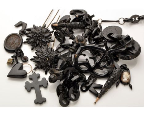 A quantity of mourning jewellery, mainly jet, to include: a crucifix pendant on button link chain; a smaller crucifix pendant