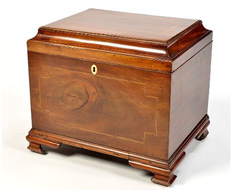 A late Georgian mahogany cellarette, the hinged lid and front decorated with inlaid banding, opening to reveal wooden bottle 