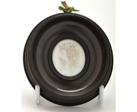An opaque white moulded glass relief portrait medallion, of youthful male figure in profile facing the left with shoulder len