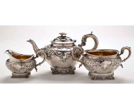 A George III three-piece tea service, probably by Robert Sharp, London 1802, each piece of squat circular form, profusely emb