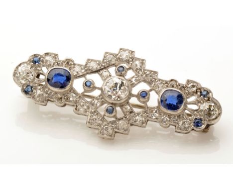 An Art Deco diamond and sapphire brooch, the central old cut diamond weighing approximately 0.30 carats, within an X-form of 