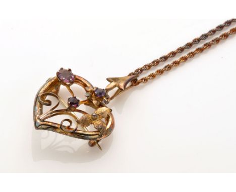 A 9ct. yellow gold and amethyst set pendant/brooch, of floral design within heart-shaped drop, on a yellow metal twisted link