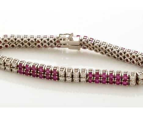 A ruby and diamond double line bracelet, set with sixty four circular facet cut rubies and forty brilliant cut diamonds, in 1