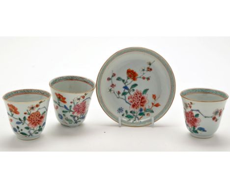 Chinese Famille Rose tea bowl and saucer, painted with floral bursts and foliage enclosed by turquoise scroll borders, 18th C