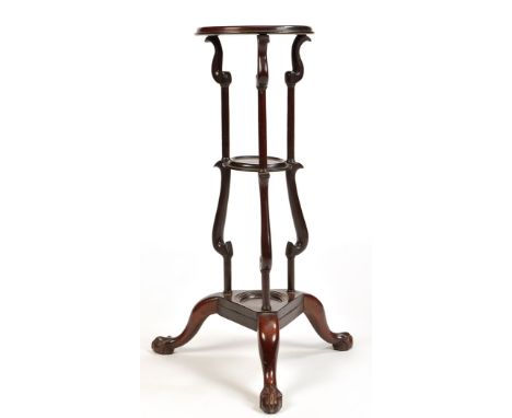 A mahogany Georgian style circular three-tier basin stand, raised on three slender turned and scrolling supports, centre soap