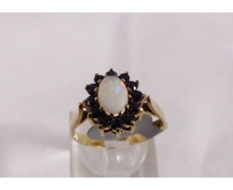 9CT OPAL CLUSTER RING. 9ct gold opal and sapphire cluster ring, Edinburgh 1979, size N