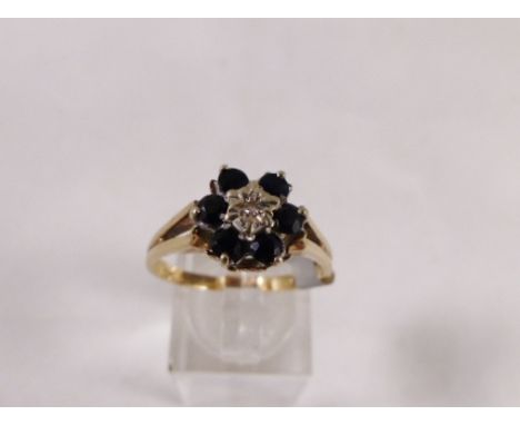 9CT CLUSTER RING. 9ct gold large sapphire and daimond cluster ring, size T