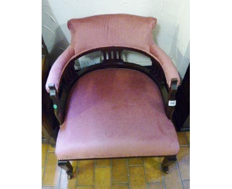VICTORIAN ARMCHAIR. Victorian low armchair on ceramic castors