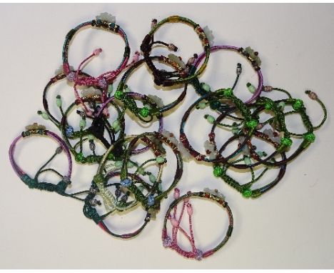 A collection of Chinese rope bracelets, with jade and agate flowerheads in various colours (16)