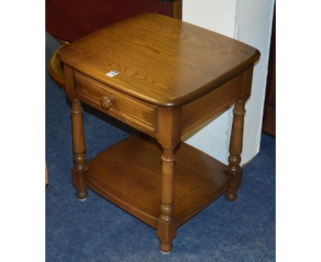 An Ercol Windsor style telephone table, with single drawer above open recess, 55cm high x 49cm wide