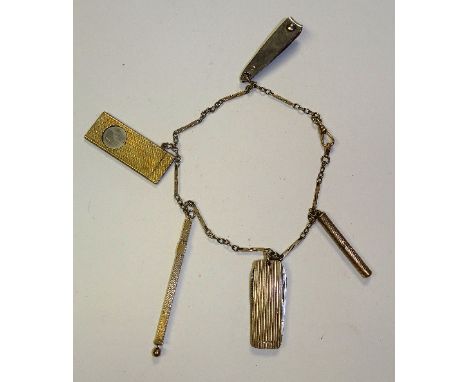 A 9ct gold chain with various 9ct gold tools attached, including a cigar cutter, penknife and propelling pencils, stamped 9ct